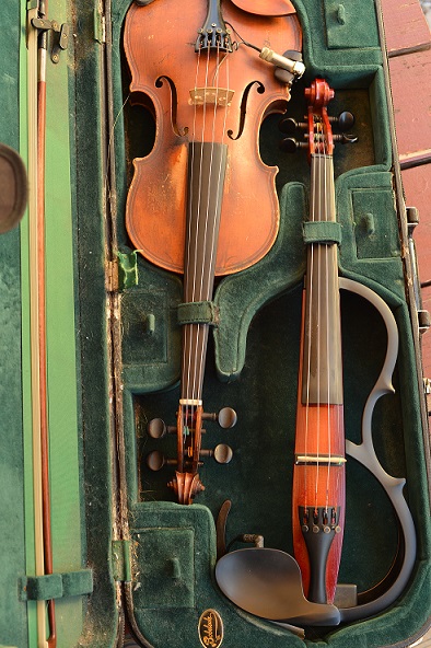 violin case with one acoustic violin and one electric violin