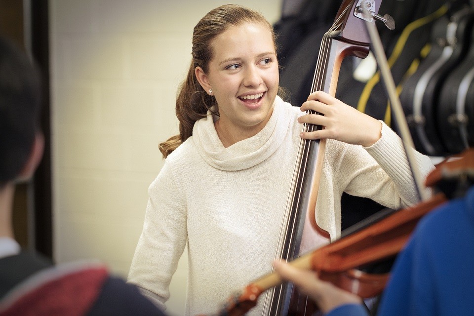 female student playing the bass