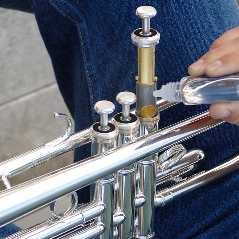 putting valve oil on a trumpet's piston