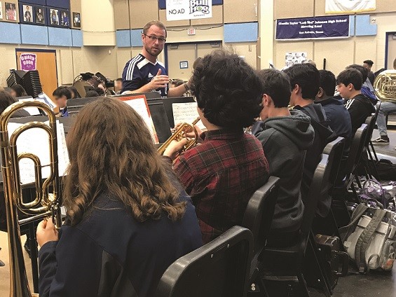 Jarret Lipman in front of a brass and woodwinds class