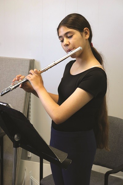 female student playing the flute