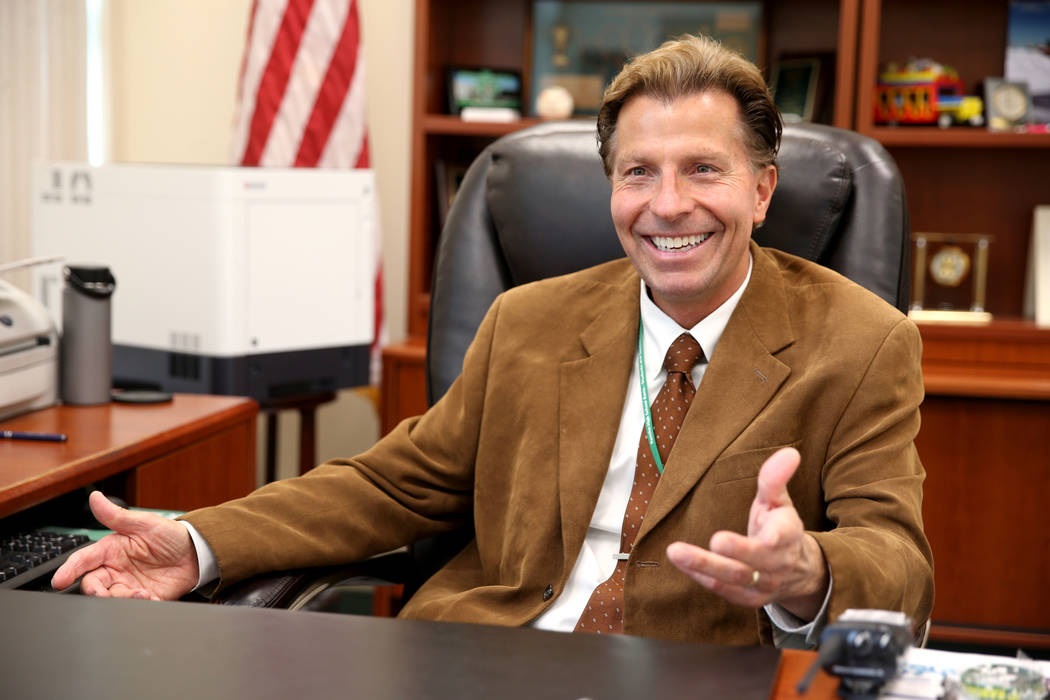 Principal Jim Kuzma sitting at desk