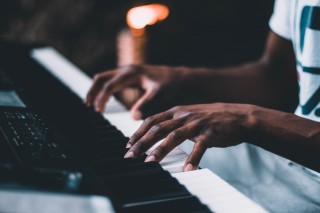 closeup of hands playing a keyboard