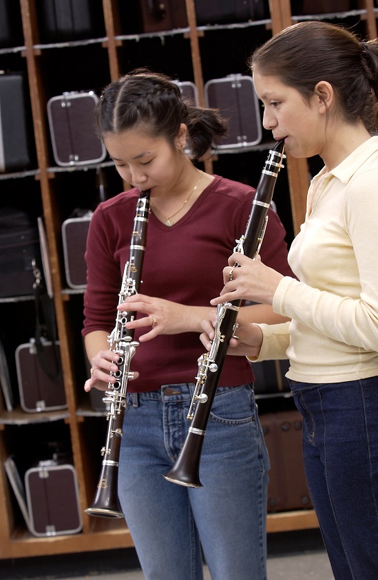 two female students playing the clarinet