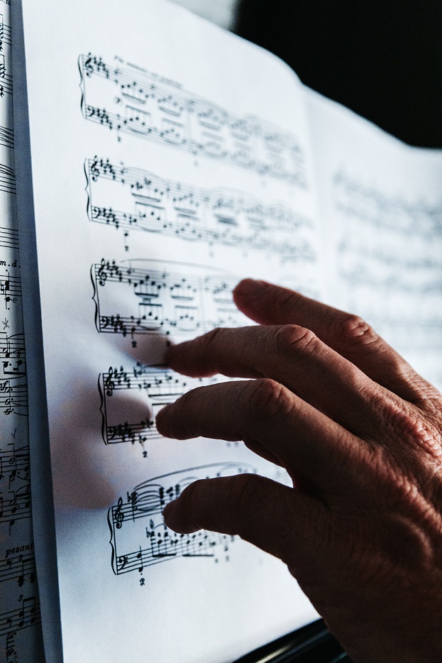 hand touching music sheet 