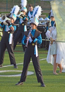 Archbishop Alter High School band in uniform performing on football field