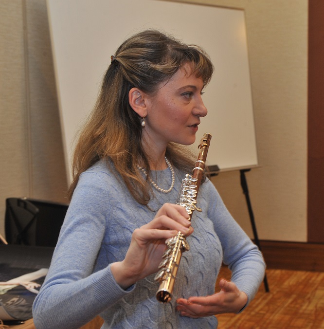 Mimi Stillman holding flute and teaching