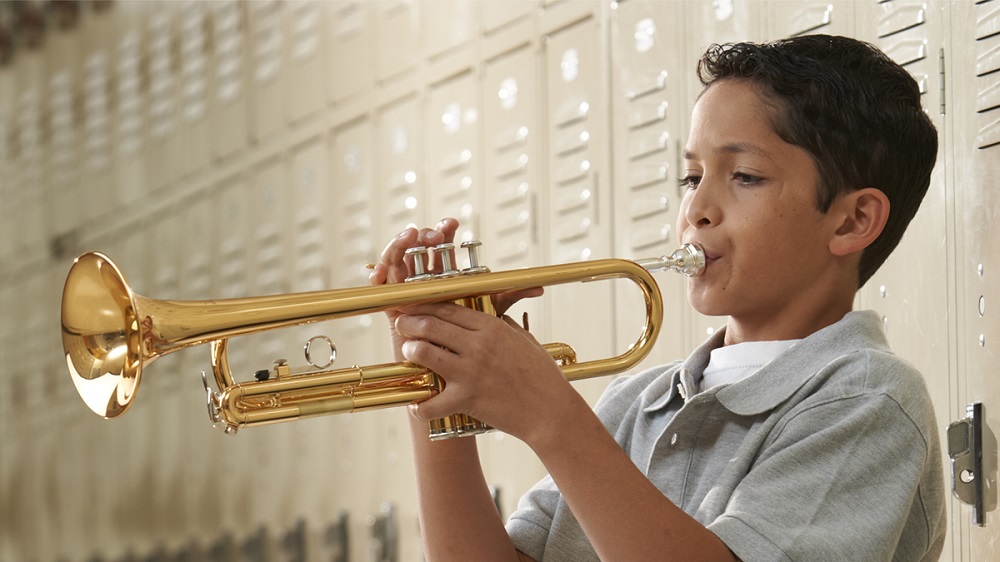 young male student playing the trumpet