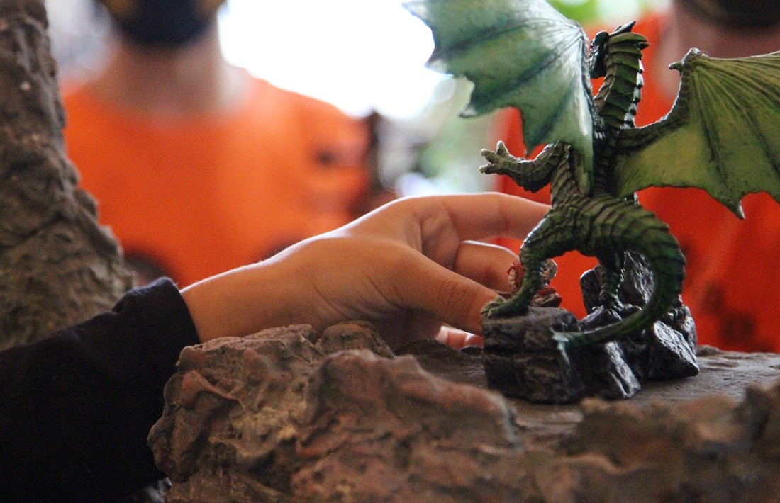 close up of student holding dragon on Novice to Ninja RPG set 