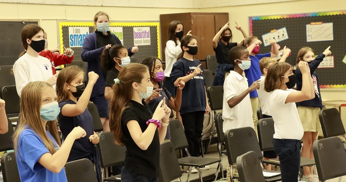 Crosby Middle School choir class making solfege hand signs 