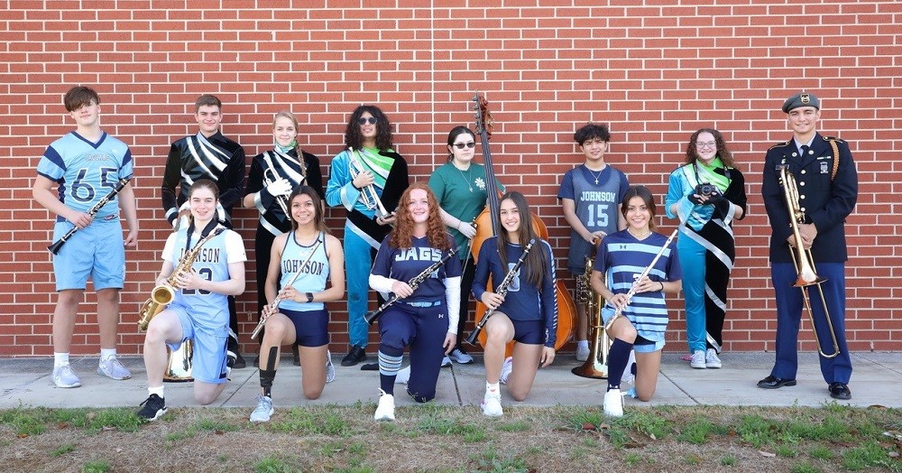 band members holding instruments and wearing sports uniforms, ROTC uniforms and other cosumes