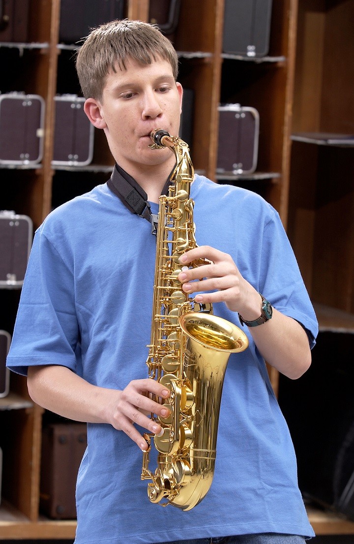 male student playing the saxophone