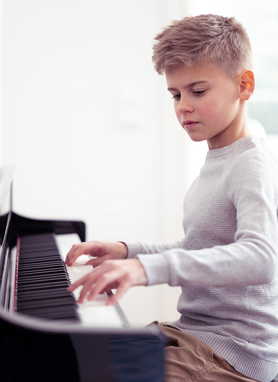 Boy Playing CLP 700 Upright Piano