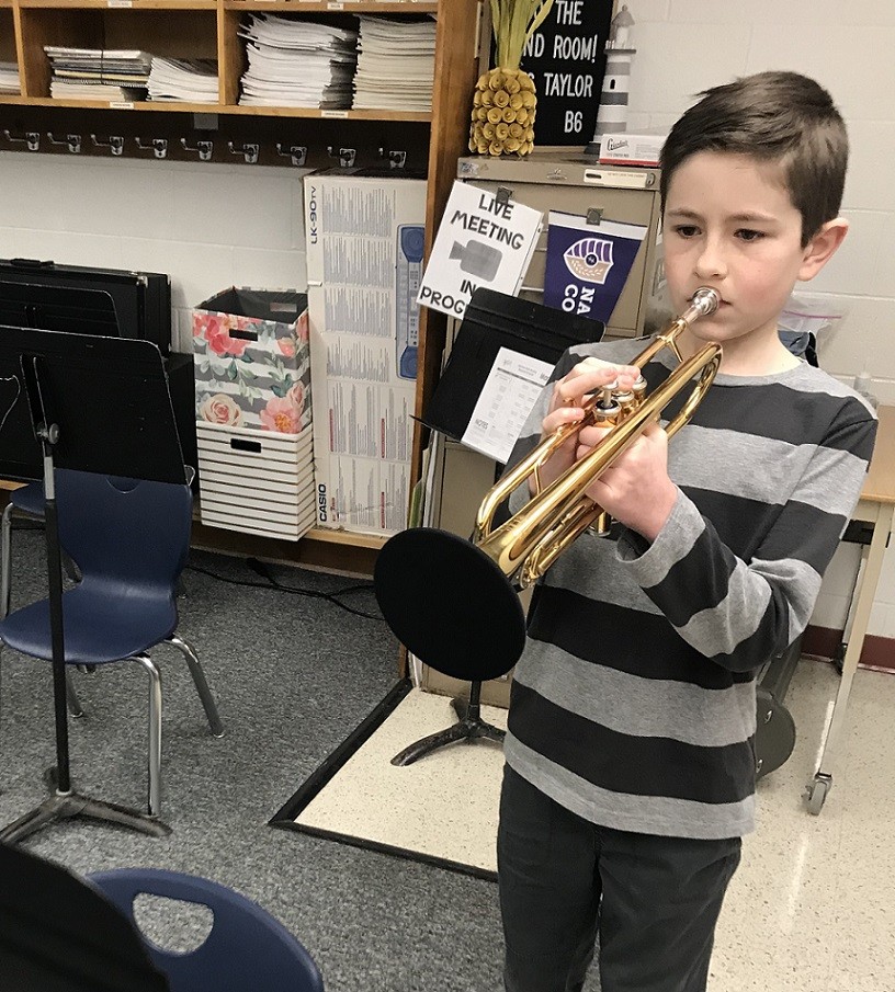 Liam Jerge plays the trumpet with bell cover.