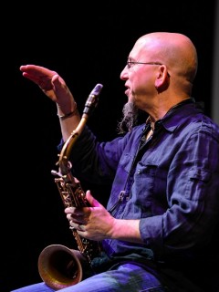 Jeff Coffin speaking and holding a saxophone