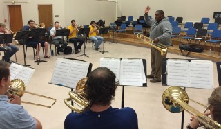 Wycliffe Gordon in front of a small group of music students