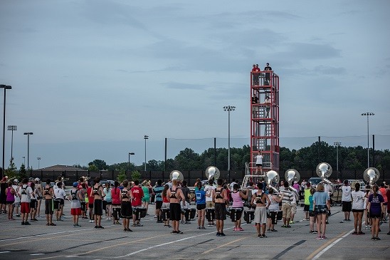 marching band practicing in parking lot