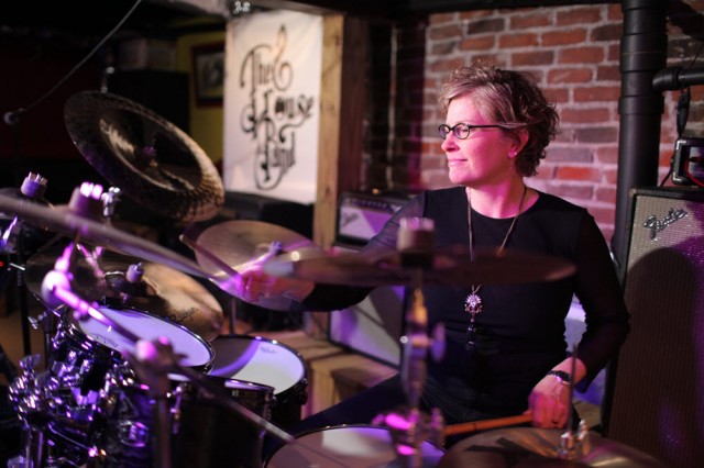 Julie Hill performing on drums