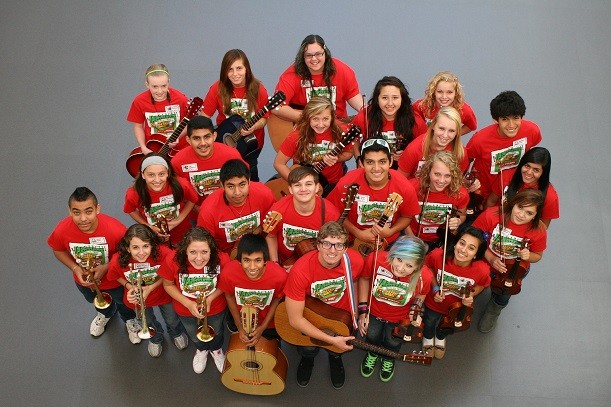 group of students in the Denison mariachi band -- all dressed in red shirts and holding various instruments