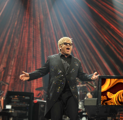 Elton John singing on stage.