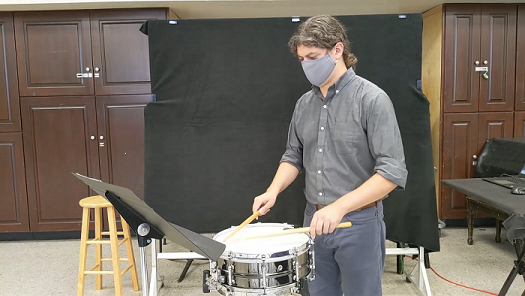 percussionist wearing mask
