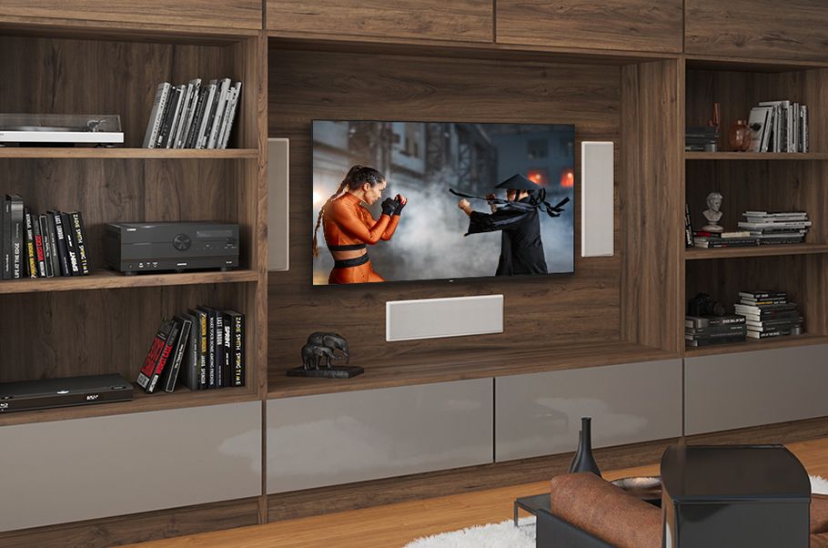 View of TV in a wall unit of bookcases.