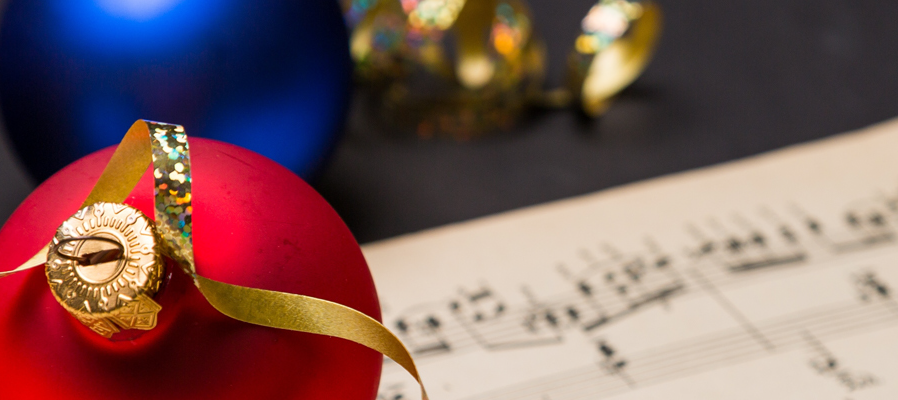 Christmas ornament adjacent to sheet music.