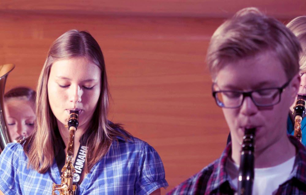 Group of students playing woodwind instruments.