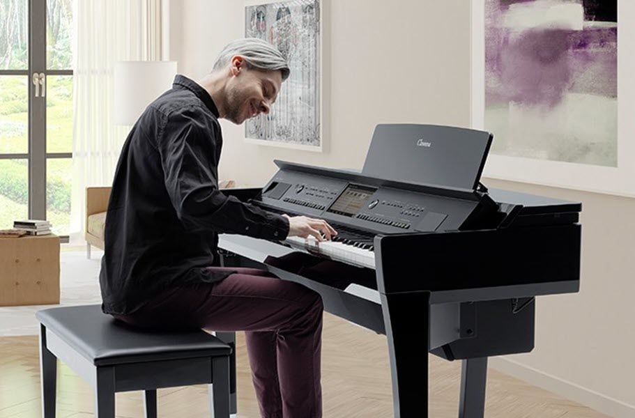 Man playing digital piano in a modern living room.