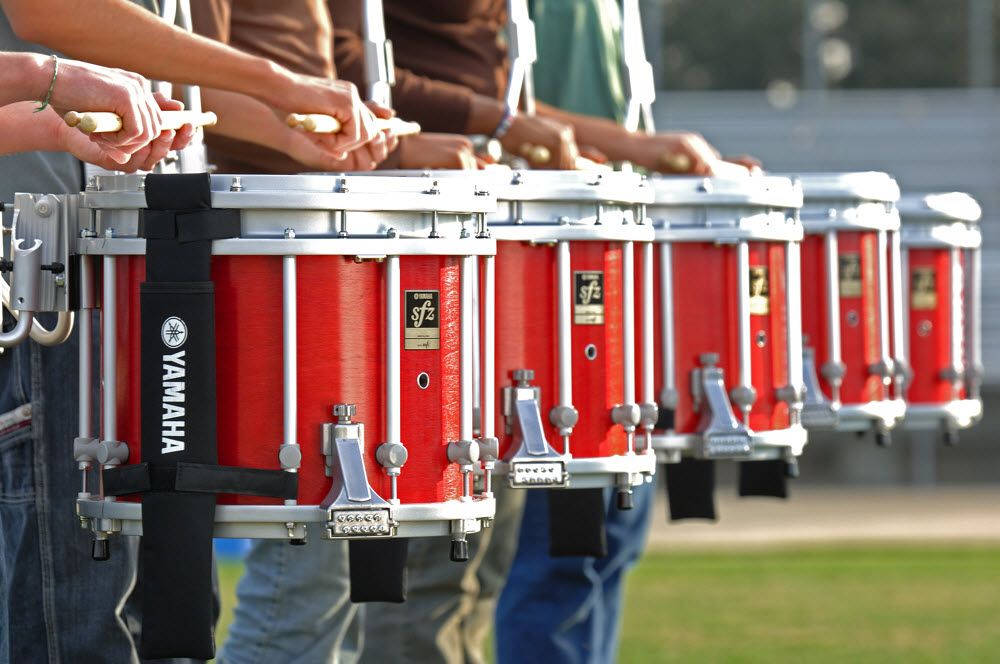 Row of drummers playing their snare drums.