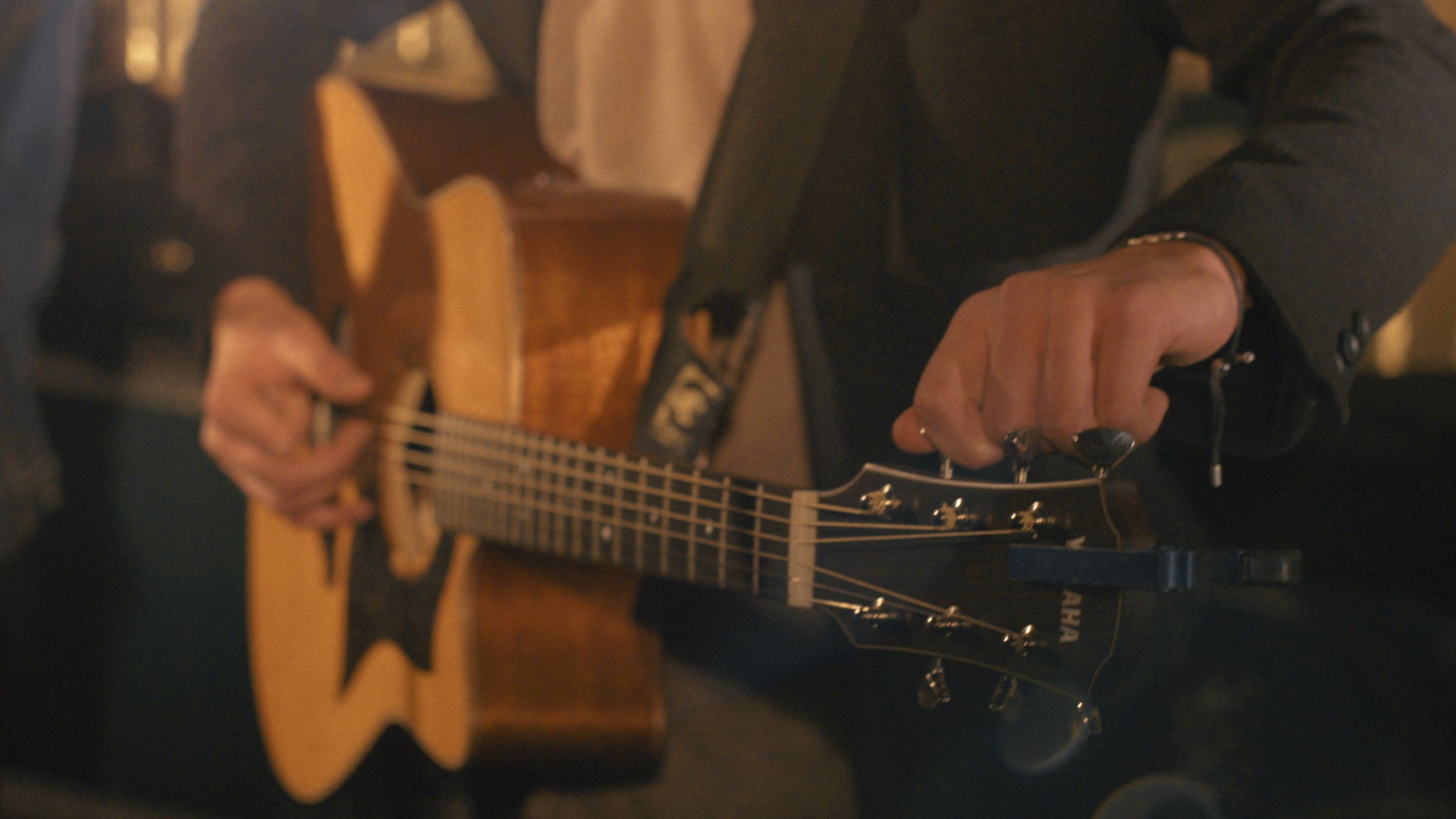 See Brooks Robertson's hands as he tunes his Yamaha acoustic guitar.