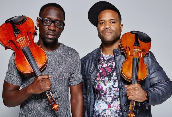 Two young African-American men with violins.