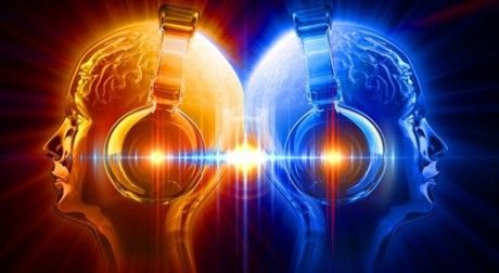 Graphical representation of two heads back to back both wearing headphones and a sound wave passing from one to the other.