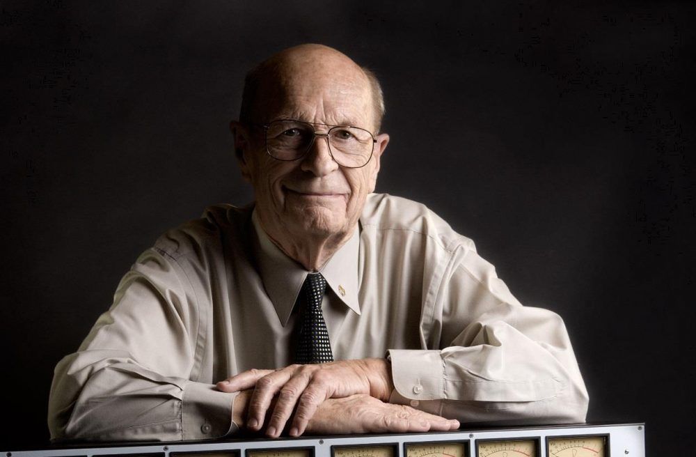 A photograph of Rupert Neve. He is an elderly man with glasses. He appears friendly and has an endearing smile.