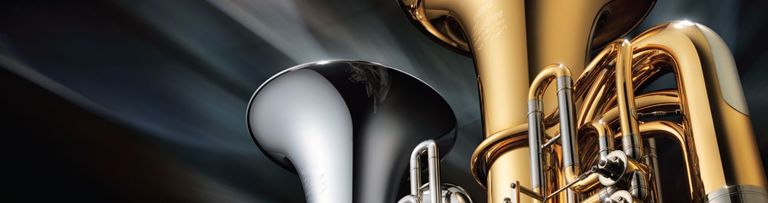 View of the bells of a brasstoned and a silvertoned tuba.