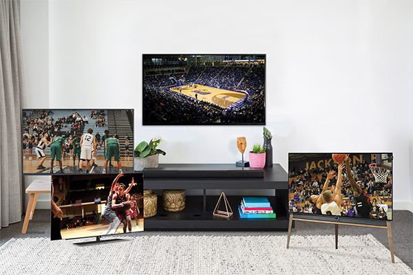 An image of 4 television sets in a room displaying basketball games.