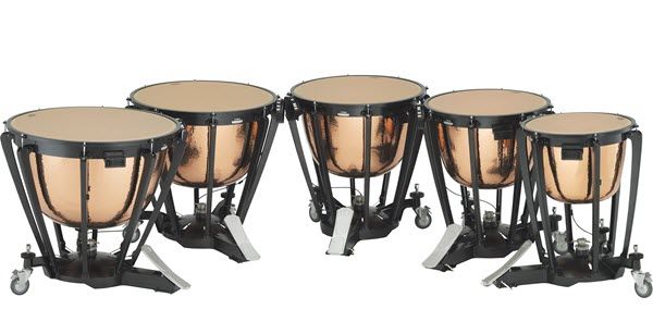 Five timpani drums in a curved row with pedals facing into center.