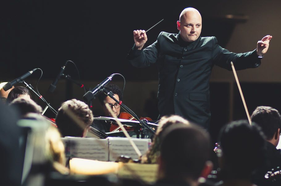 Conductor conducting an orchestra.