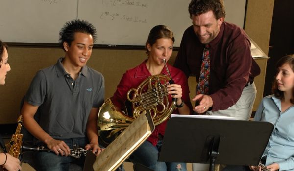 music teacher with four music students