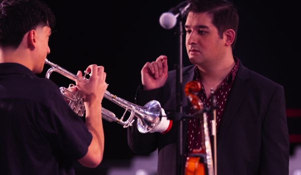 music teacher talking to trumpet player