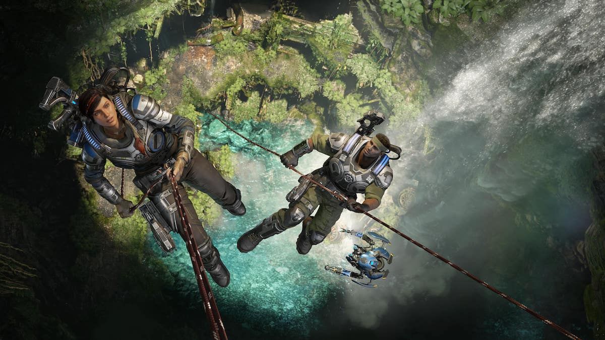 Characters descend from rope into a cave pool in scene from Gears 5.