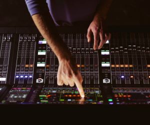 man pointing at audio mixer