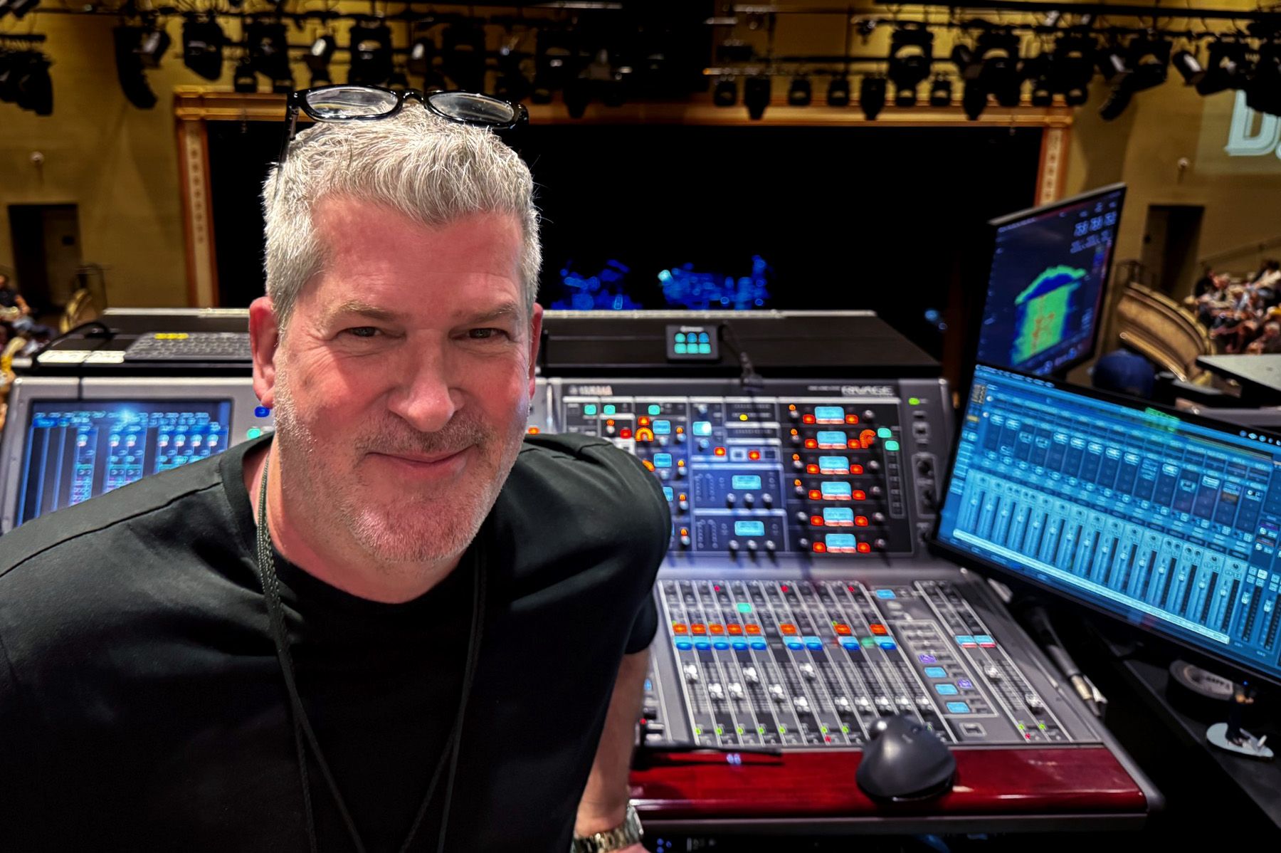 man next to audio mixer