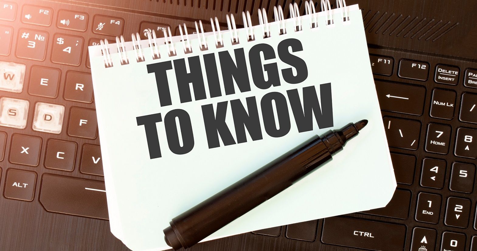 notebook on top of computer keyboard with the words "Things to Know" written in it