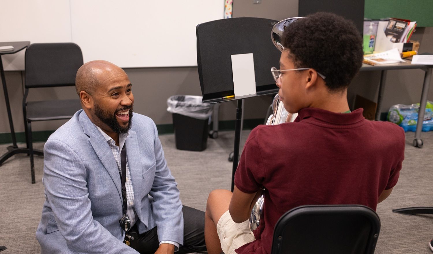 teacher engaging with band student