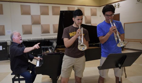 Denis DiBlasio on piano with two jazz trumpet students