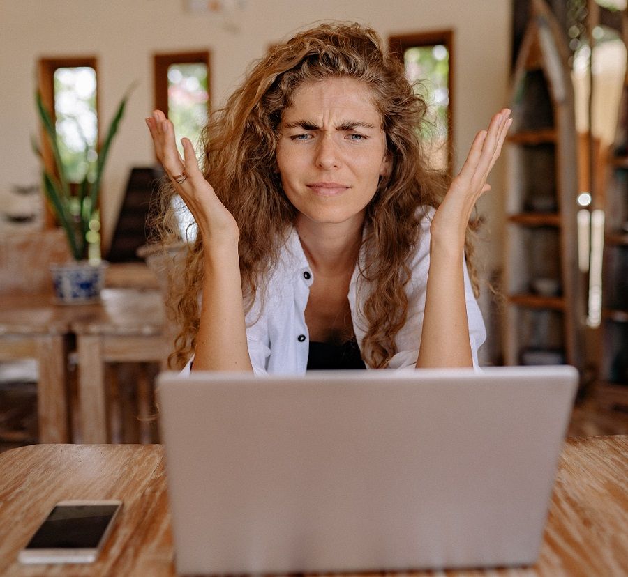 frustrated woman sitting in front of laptop