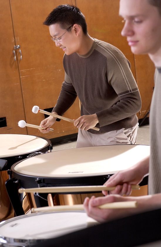 male student playing timpani