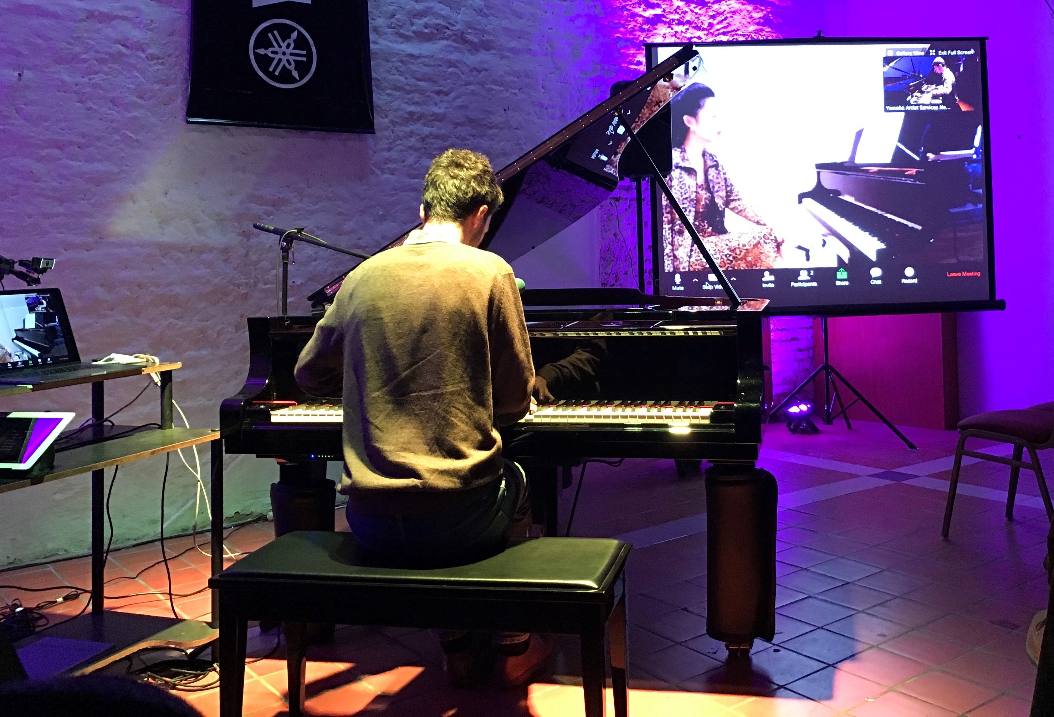 An image of a man playing a piano.