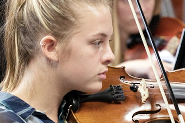 Young girls playing violin.